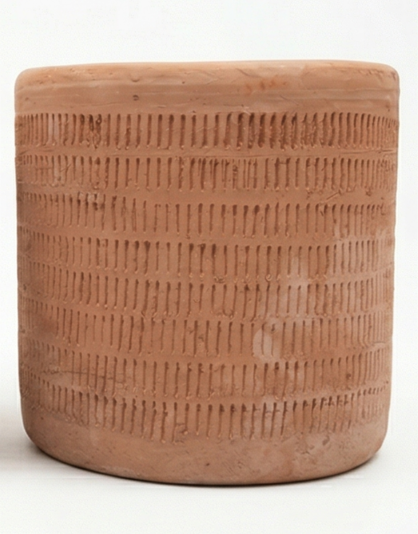 A terracotta planter by Clay Imports with etched vertical lines and a rustic finish.