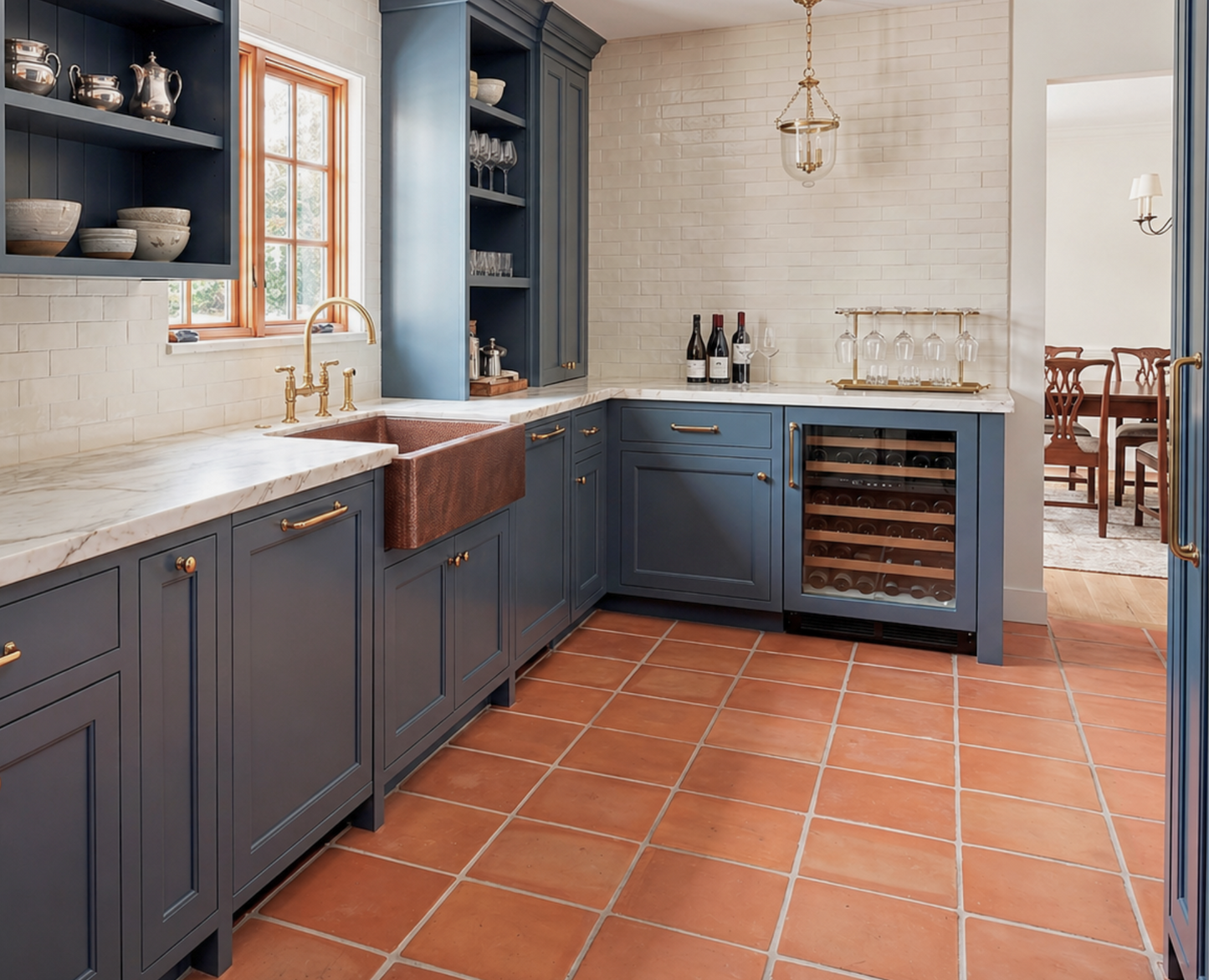 Modern kitchen with blue cabinets, marble countertops, and a wine cooler.