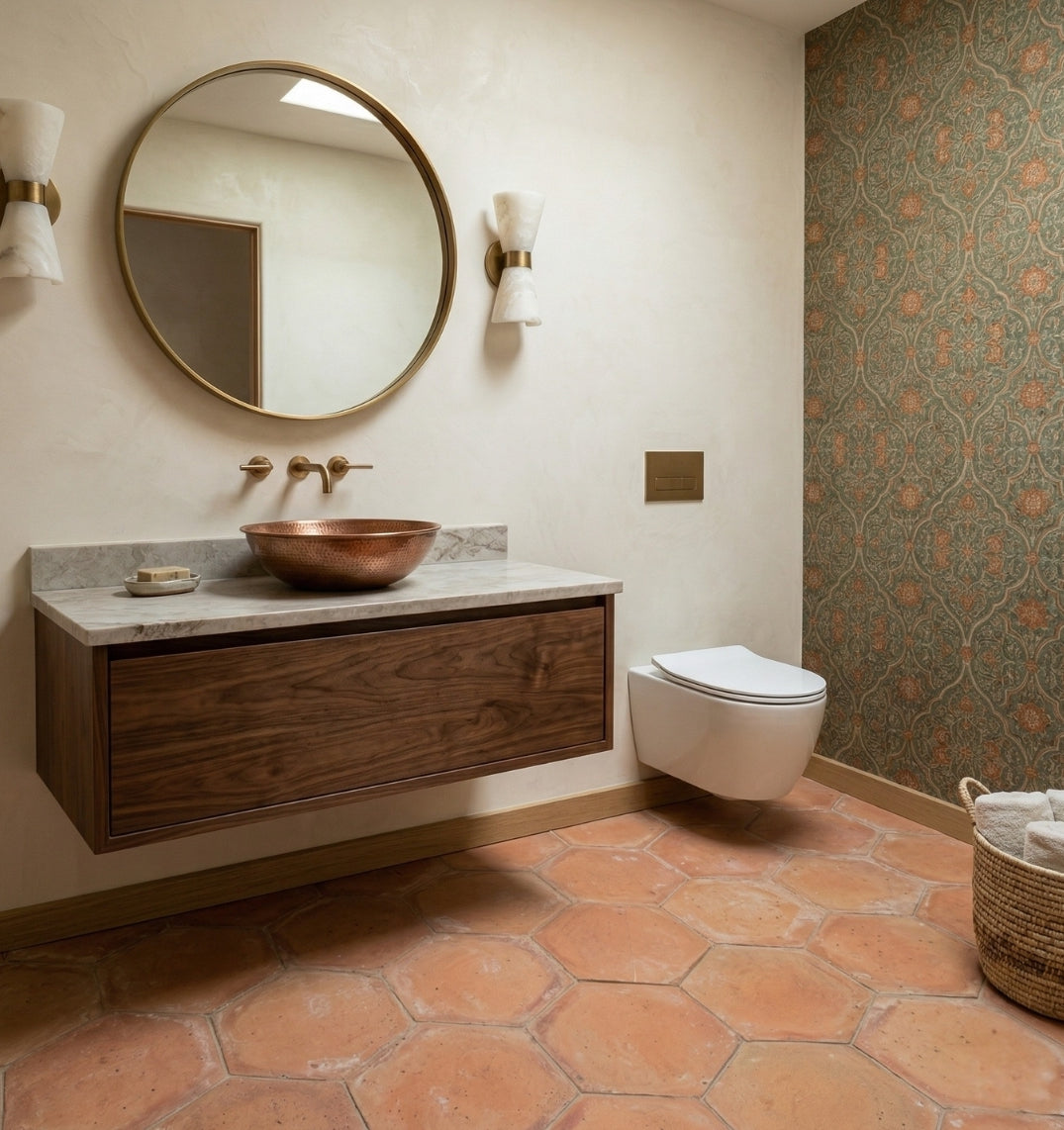 Organic terracotta hexagon tiles by Clay Imports in a rustic red-orange on a bathroom floor.