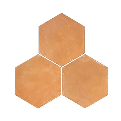 Organic terracotta hexagon tiles from Clay Imports in a light orange-brown hue, arranged in a cluster of three.