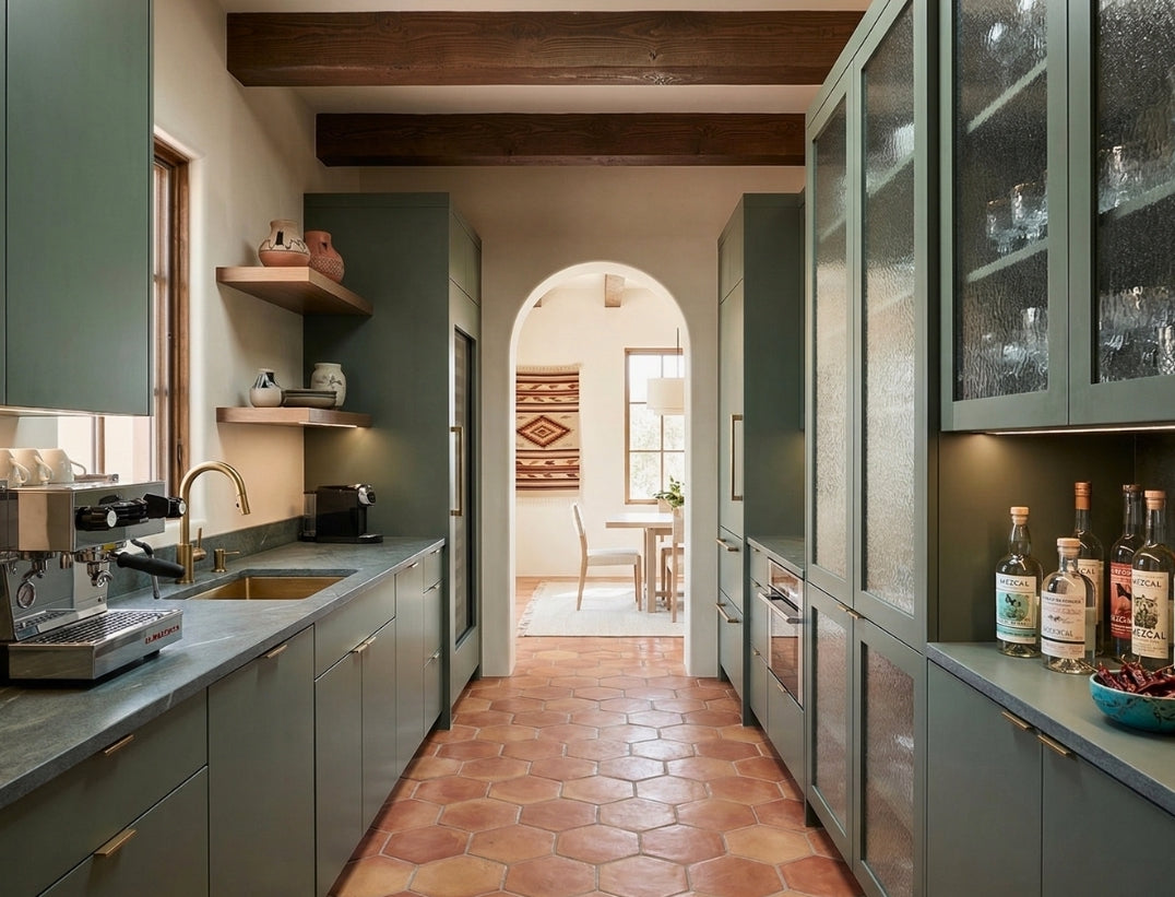 Natural reddish-brown rounded hexagon terracotta floor tiles by Clay Imports in a long galley kitchen.