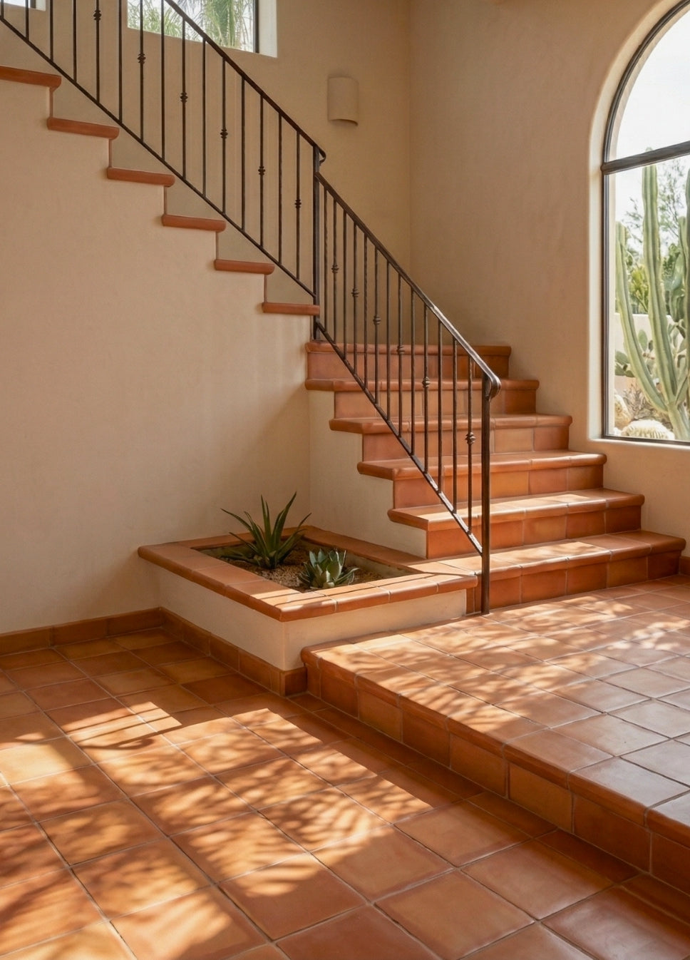Smooth gloss natural terracotta coping trim by Clay Imports, showcasing its rounded edge on stairs and a planter.