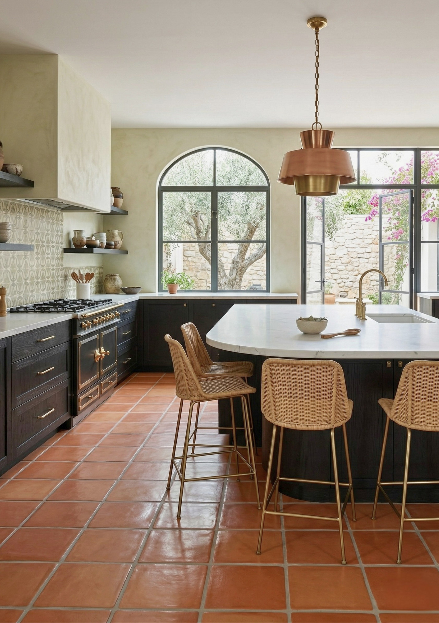 Rounded 12x12 terracotta tiles from Clay Imports, with a warm reddish-brown finish on a kitchen floor.