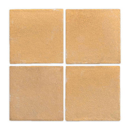 Four square beige Cotto tiles by Clay Imports, arranged in a grid with a matte, sandy texture.