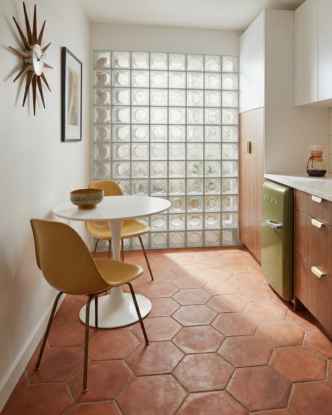 Reddish-brown hexagon Cotto tiles from Clay Imports covering a sunlit kitchen floor.