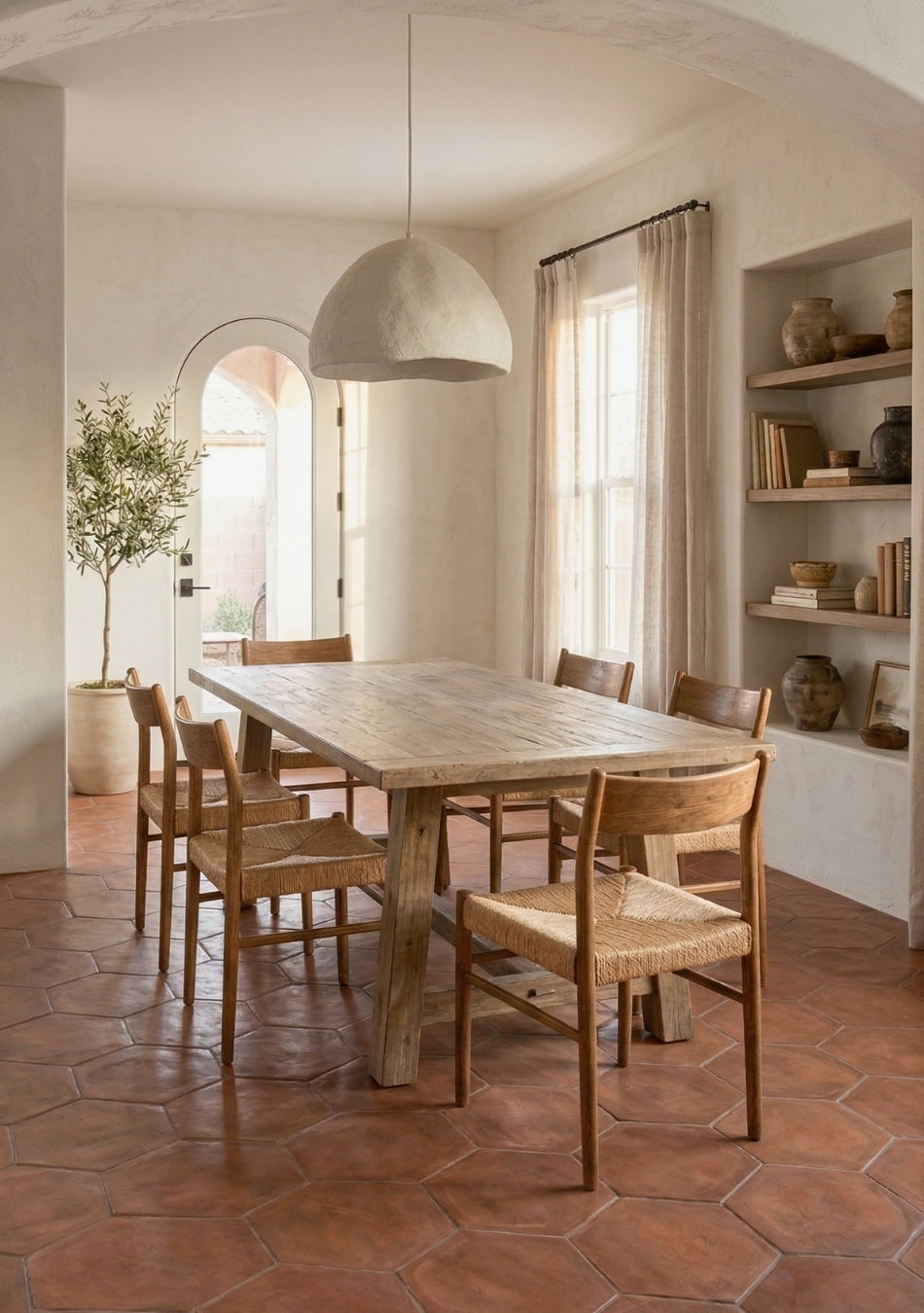 Cotto Umber Hexagon tiles by Clay Imports covering a rustic dining room floor with wooden furniture.
