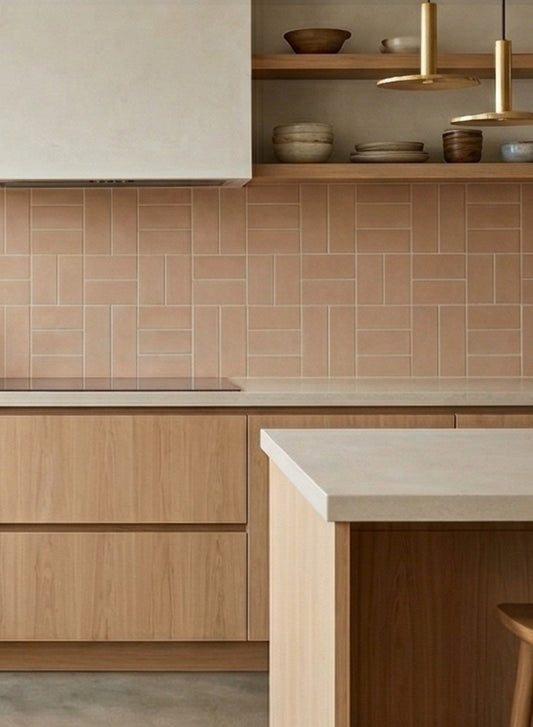 Opaque rectangular clay tiles in muted peach by Clay Imports, arranged in a geometric pattern as a kitchen backsplash.