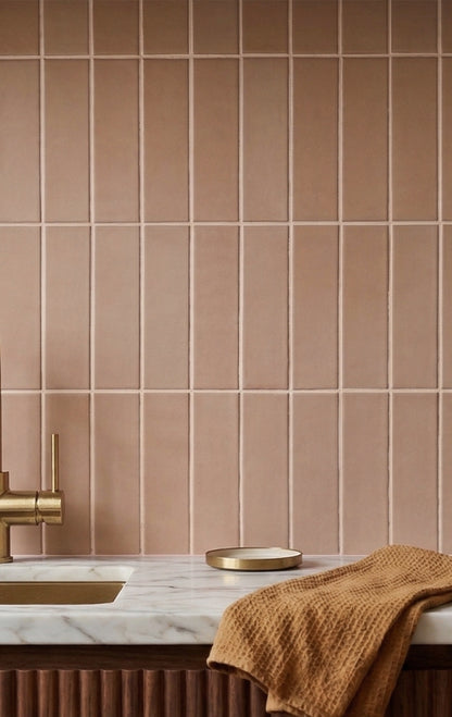 Opaque 2x8 rectangular blush clay tiles by Clay Imports installed vertically as a kitchen backsplash.