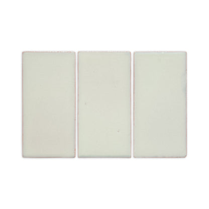 Three pale green rectangular clay tiles by Clay Imports with reddish-pinkish edges, displayed in a row.
