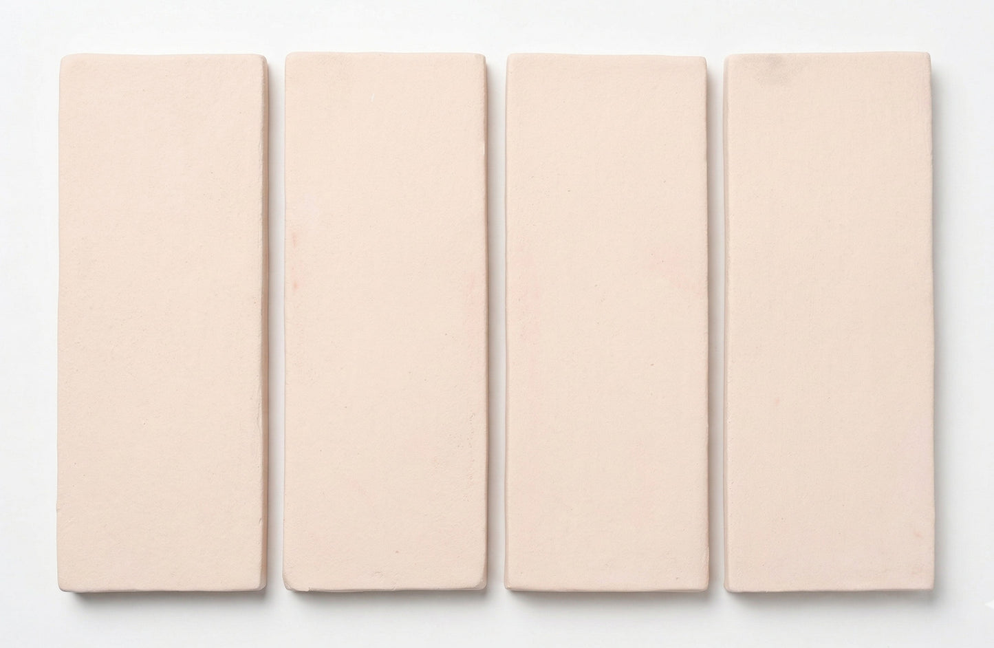 Four Horizon Straw Hat Matte 2x6 tiles by Clay Imports, showing their subtle textured finish.