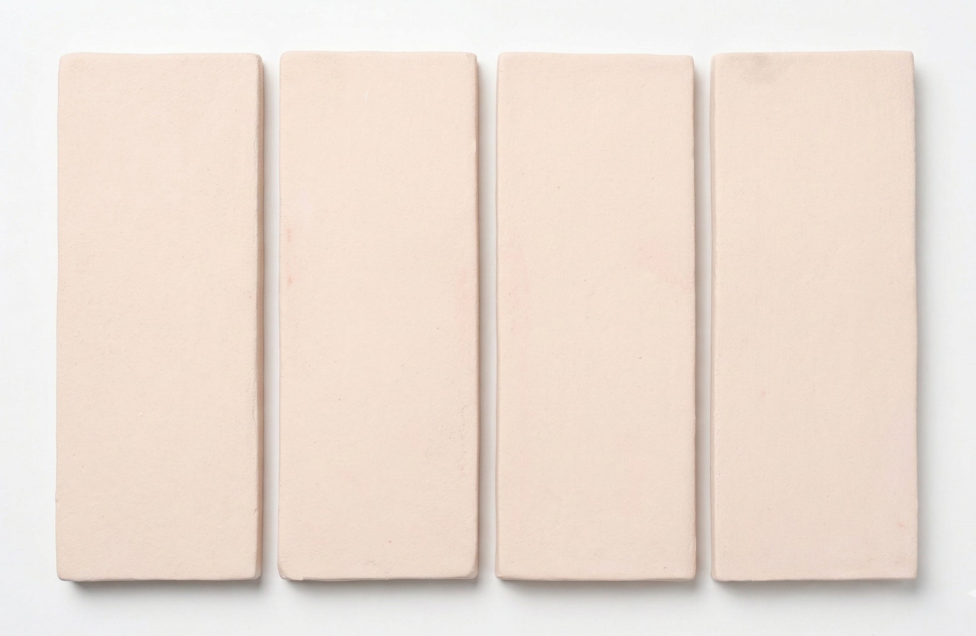 Four Horizon Straw Hat Matte 2x6 tiles by Clay Imports, showing their subtle textured finish.