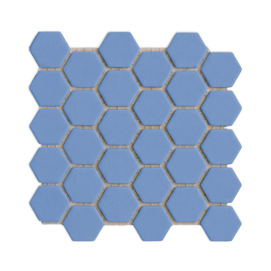 Denim blue hexagon clay tile by Clay Imports, arranged in a meshed pattern with white grout lines on a white background.