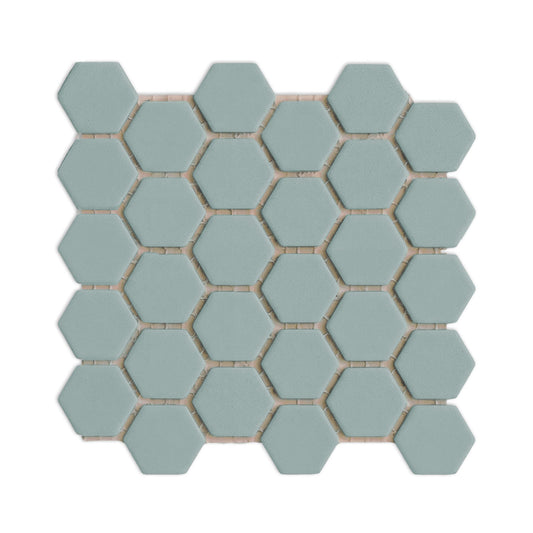 Sage green hexagon clay tiles by Clay Imports, arranged in a meshed pattern with white grout lines and subtle shadows.
