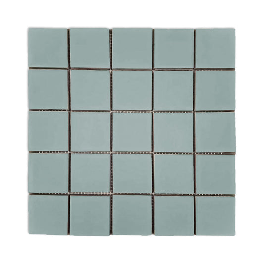 Greenish-gray meshed 2x2 clay tiles by Clay Imports, arranged in a uniform grid with thin white grout lines.