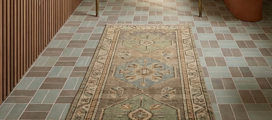 Agave clay floor tiles by Clay Imports, in muted green and brown geometric pattern, with a patterned runner rug.