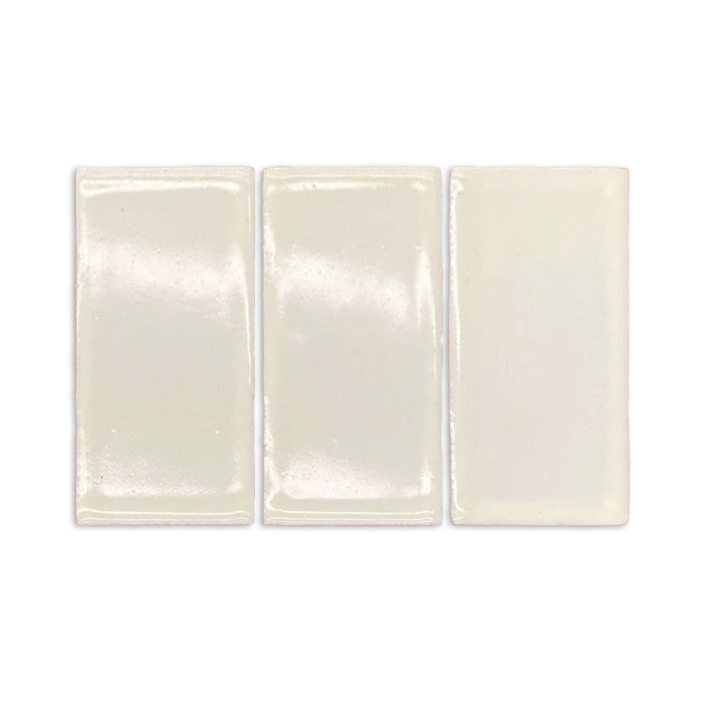 Three rectangular Blanco Mexicano gloss tile samples by Clay Imports, with subtle variations and shiny finish.