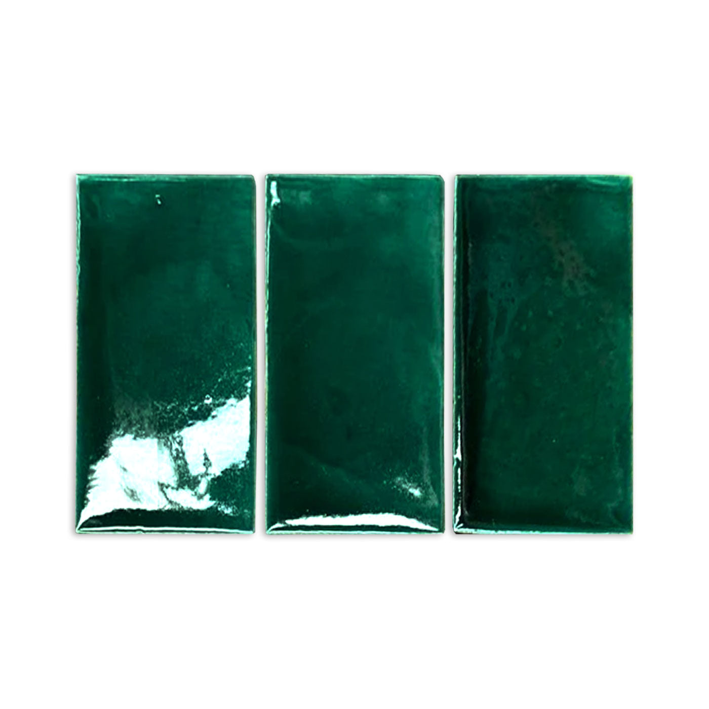 Three rectangular forest green glossy tile samples by Clay Imports with subtle color variation and texture.