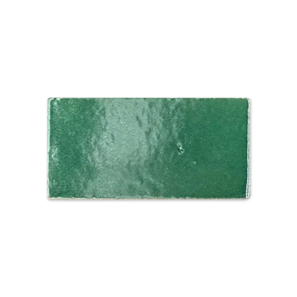 Green glossy rectangular tile sample by Clay Imports with a slightly uneven, reflective surface.