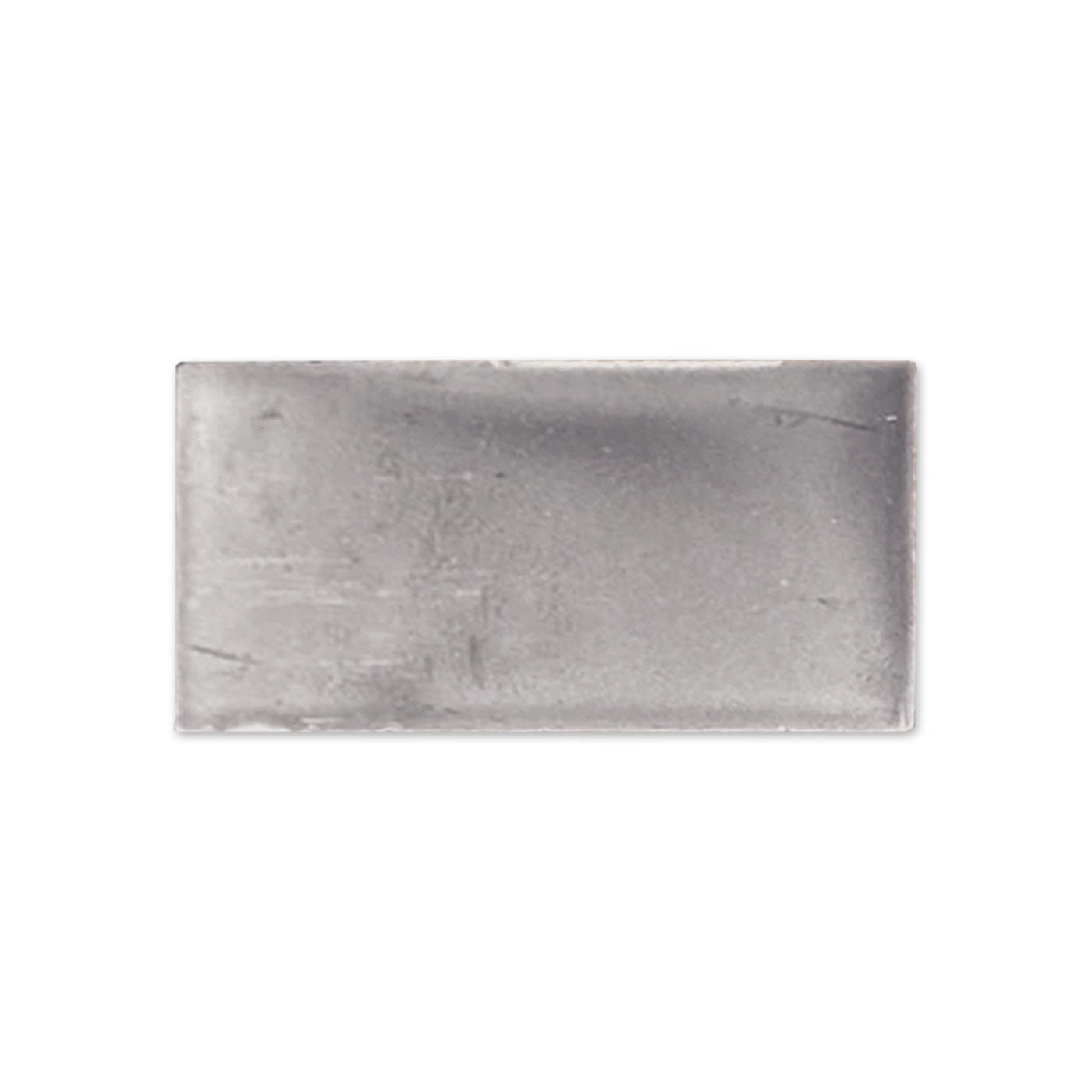 Graphite gloss tile sample by Clay Imports, a dark grey rectangular piece with subtle texture and soft edges.