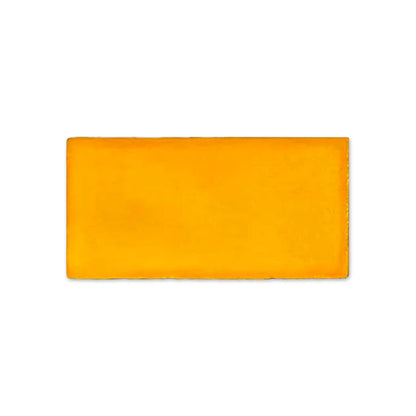 Bright orange-yellow Mango Gloss Sample from Clay Imports, a rectangular block with slightly uneven edges.