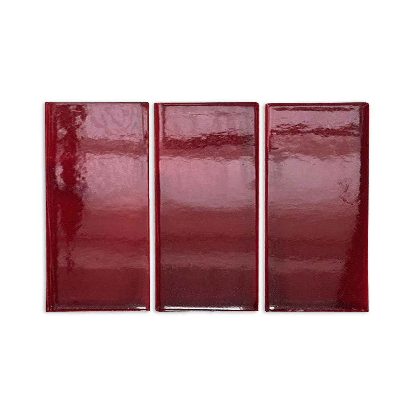 Three rectangular oxblood gloss tile samples by Clay Imports, arranged side-by-side with reflective surfaces.