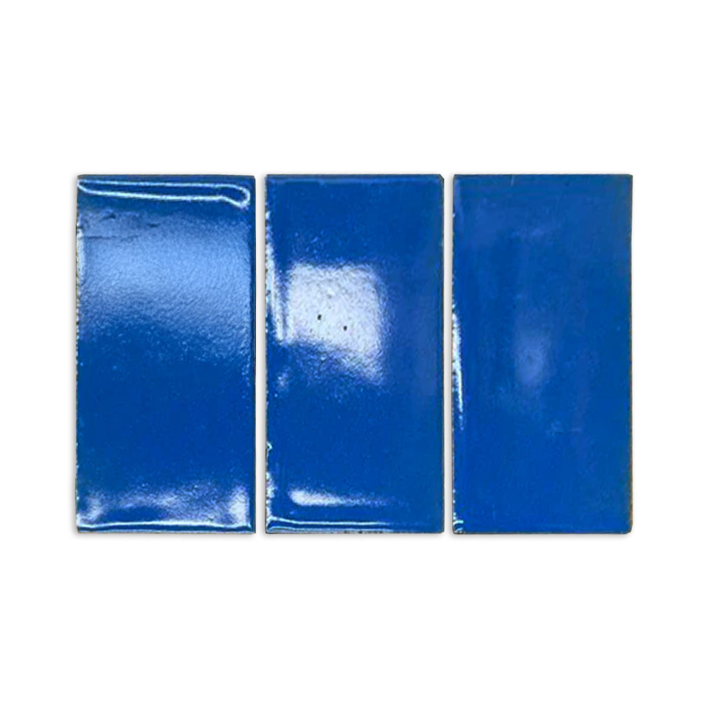 Prussian blue gloss tile sample by Clay Imports, three rectangular pieces with a shiny finish.