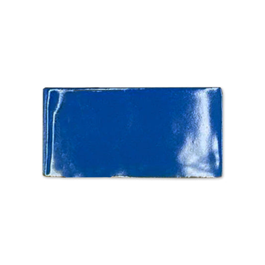 Prussian Gloss Sample tile, deep blue, by Clay Imports, with a highly reflective finish and slightly irregular edges.