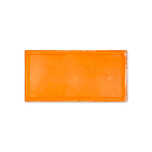 Orange gloss sample tile by Clay Imports, rectangular with slightly irregular edges on white background.