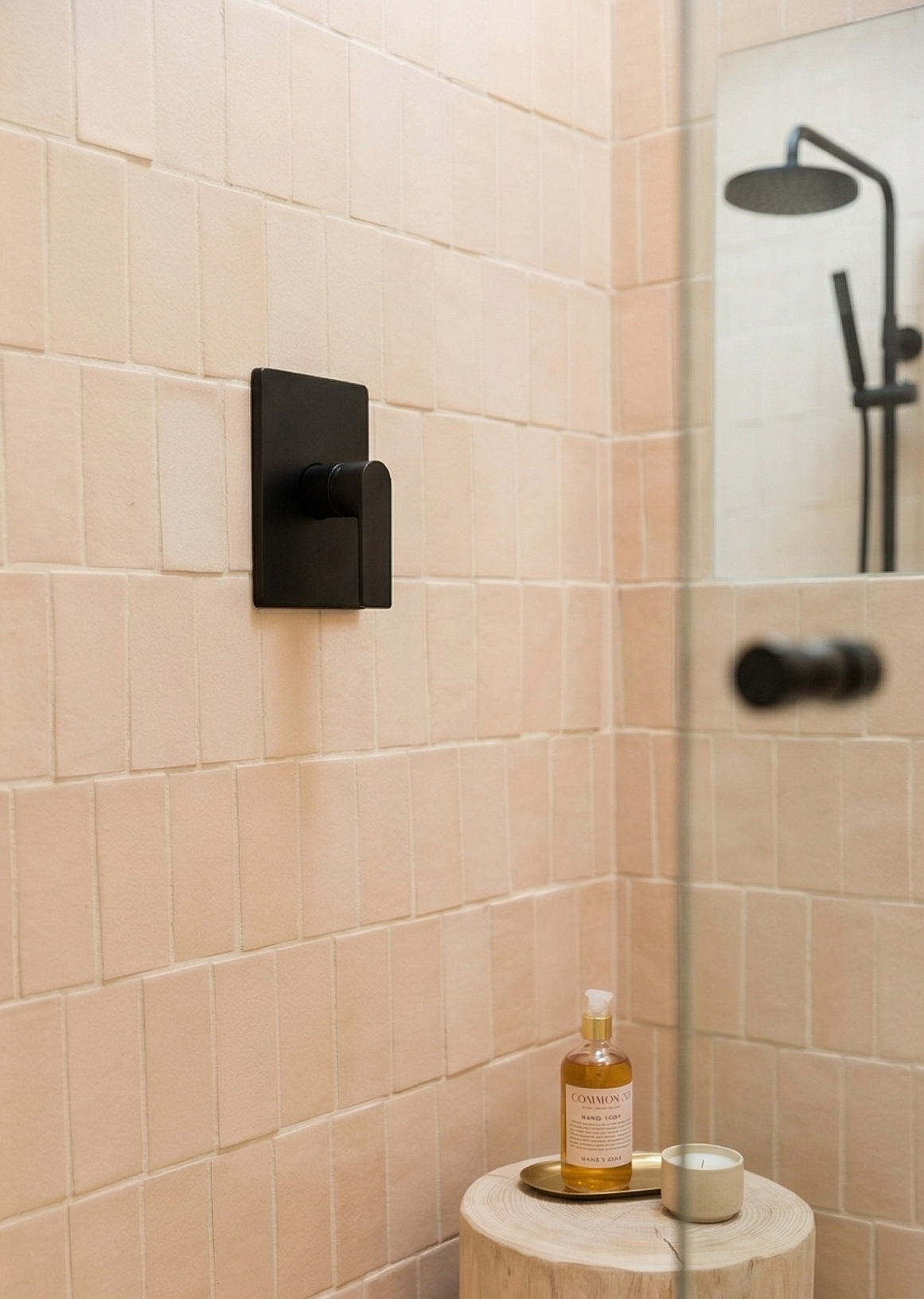 Light peach rectangular clay tile by Clay Imports, installed vertically as shower walls with matte black fixtures.