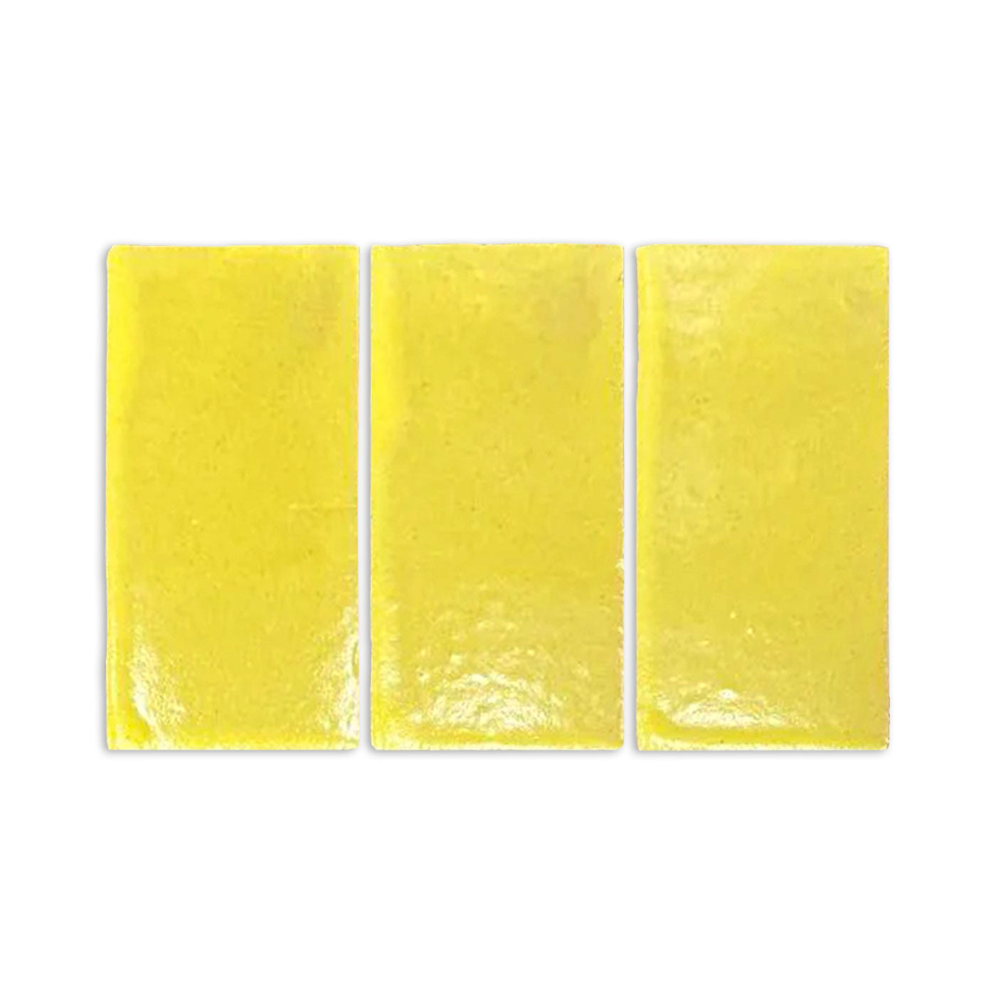 Yellow gloss sample by Clay Imports, three rectangular pieces with a reflective, slightly textured surface.