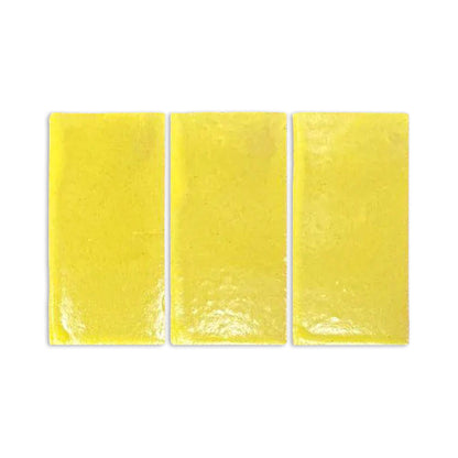 Yellow gloss sample by Clay Imports, three rectangular pieces with a reflective, slightly textured surface.