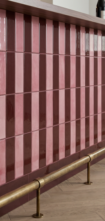 Pink and brown striped tiles with a gold handrail on a wooden floor.