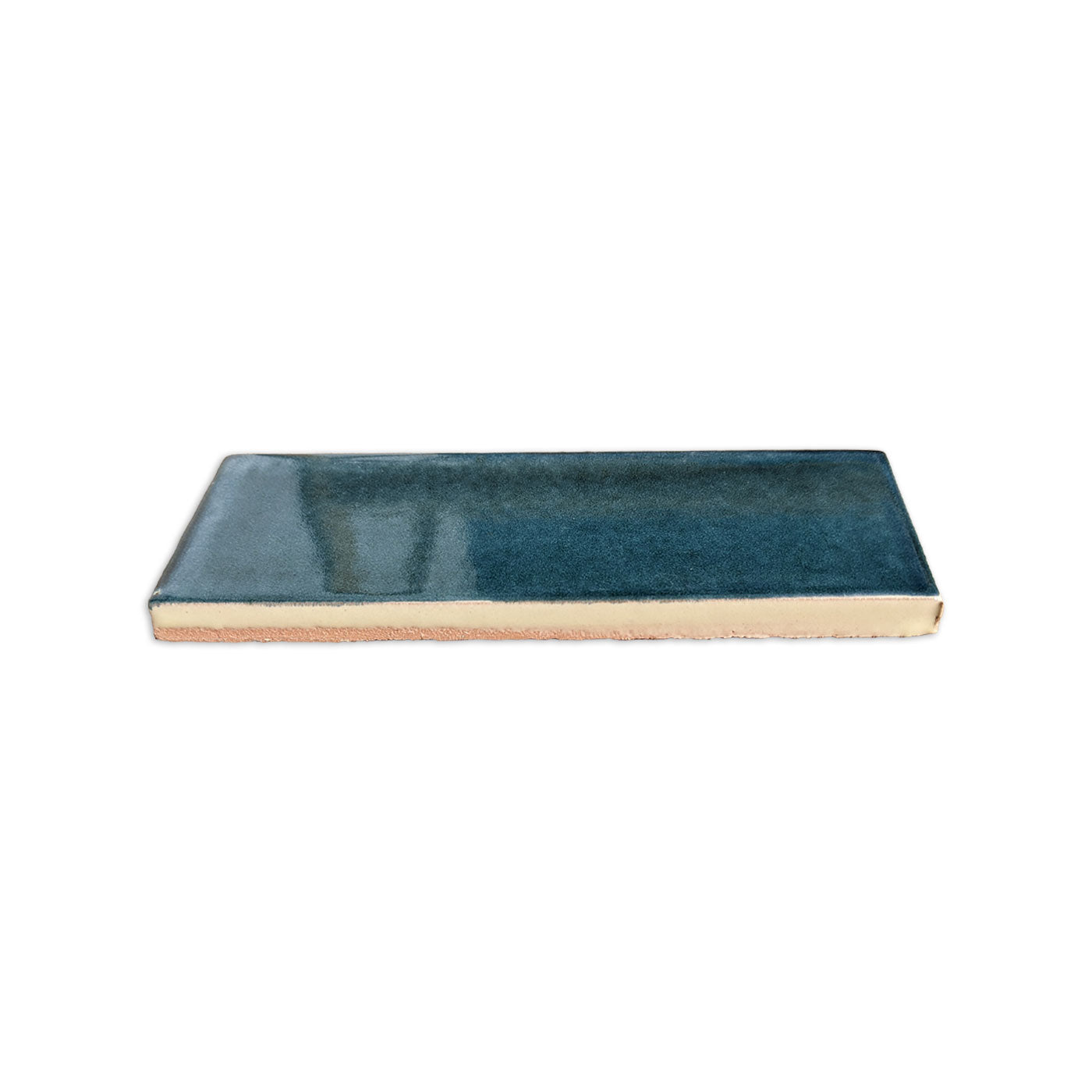 Botanical Teal rectangular clay tile by Clay Imports, with a glossy glaze and visible unglazed side.