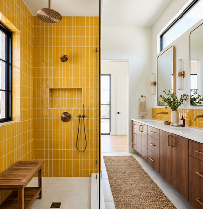 Yellow 2x6 solid tile by Clay Imports, installed vertically in a modern bathroom shower and vanity.