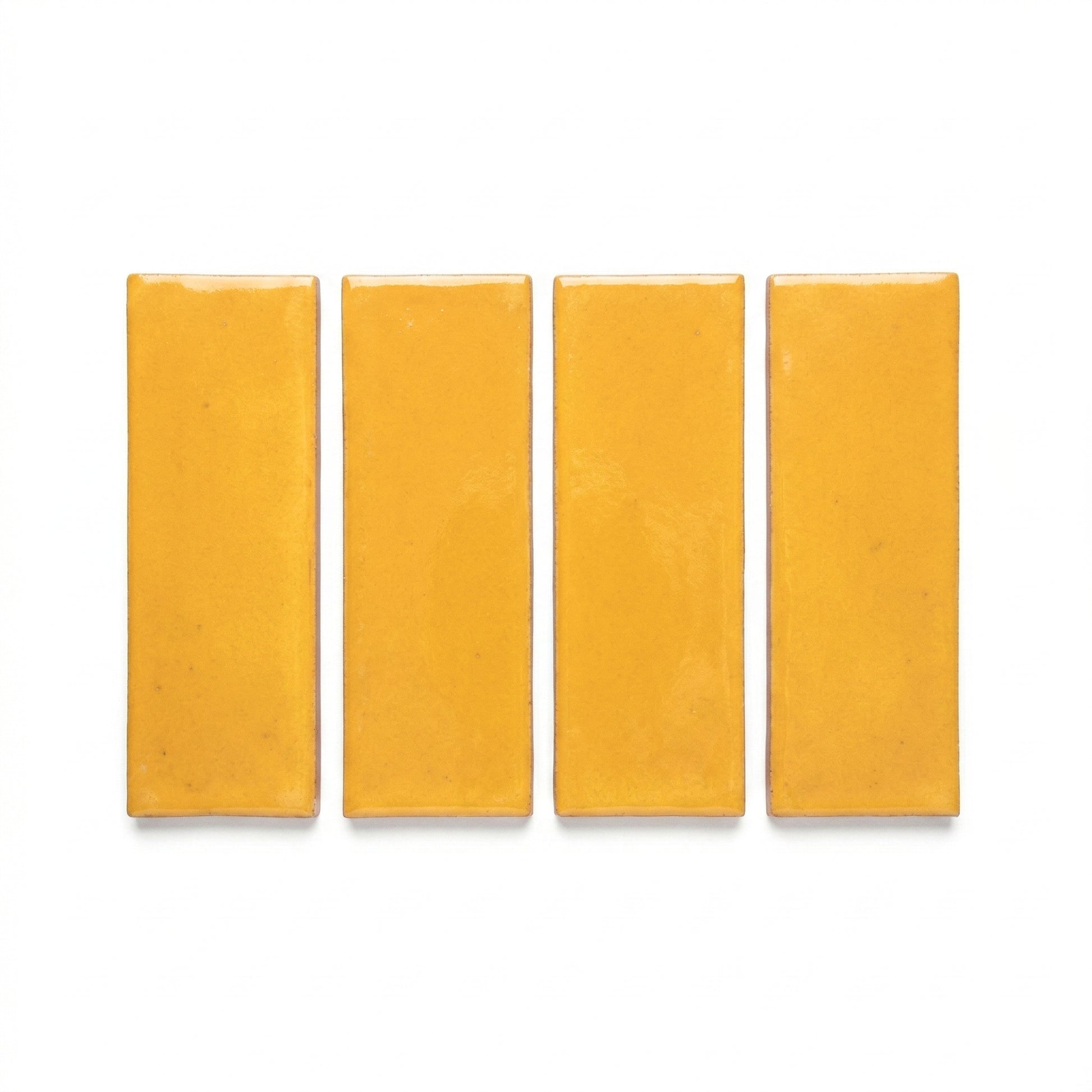 Four rectangular Elote golden yellow solid tiles by Clay Imports with a glossy finish.