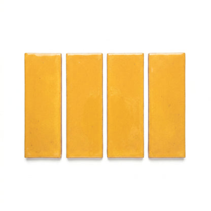 Four rectangular Elote golden yellow solid tiles by Clay Imports with a glossy finish.