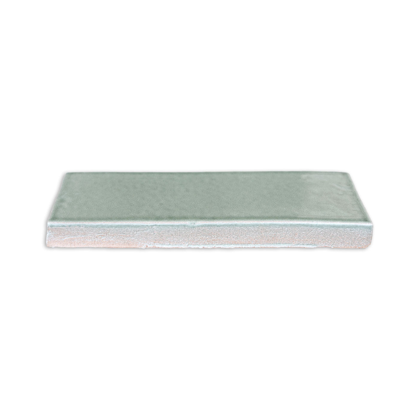 Light greenish-blue Arctic Gloss 2x6 tile by Clay Imports, with a glossy top and textured unglazed side.