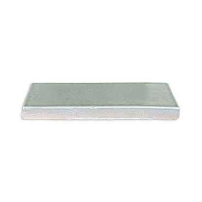 Light greenish-blue Arctic Gloss 2x6 tile by Clay Imports, with a glossy top and textured unglazed side.