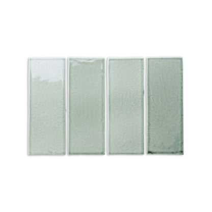 Arctic Gloss tile by Clay Imports: Four light sage green rectangular tiles with a glossy, uneven surface and subtle color variations.
