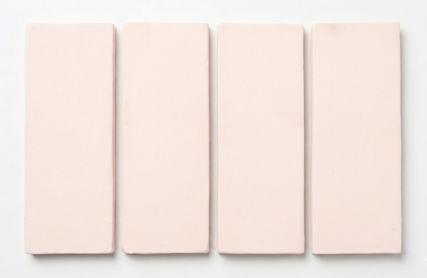 Matte light pink rectangular tiles by Clay Imports, arranged vertically with soft edges.