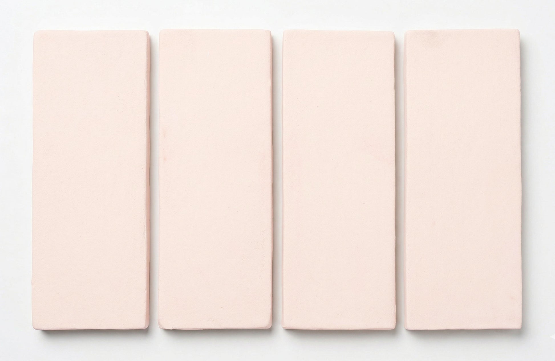 Matte light pink rectangular tiles by Clay Imports, arranged vertically with soft edges.