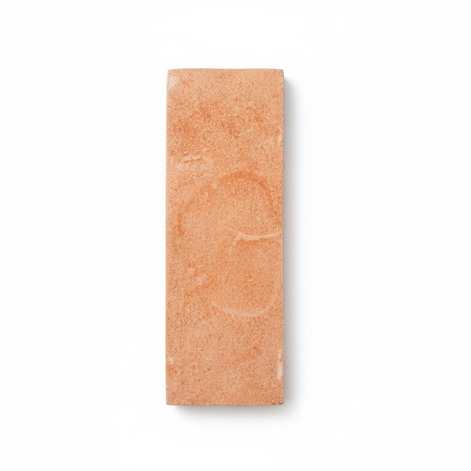 Matte terracotta 2x6 tile sample by Clay Imports, featuring a sandy texture and subtle swirling patterns on a white background.