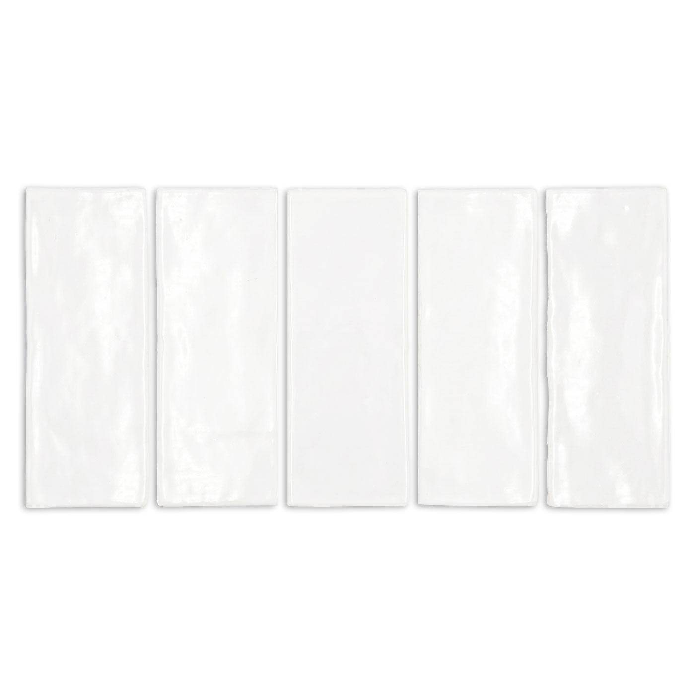 Five white gloss tiles from Clay Imports, rectangular with subtle undulations and slightly irregular edges.