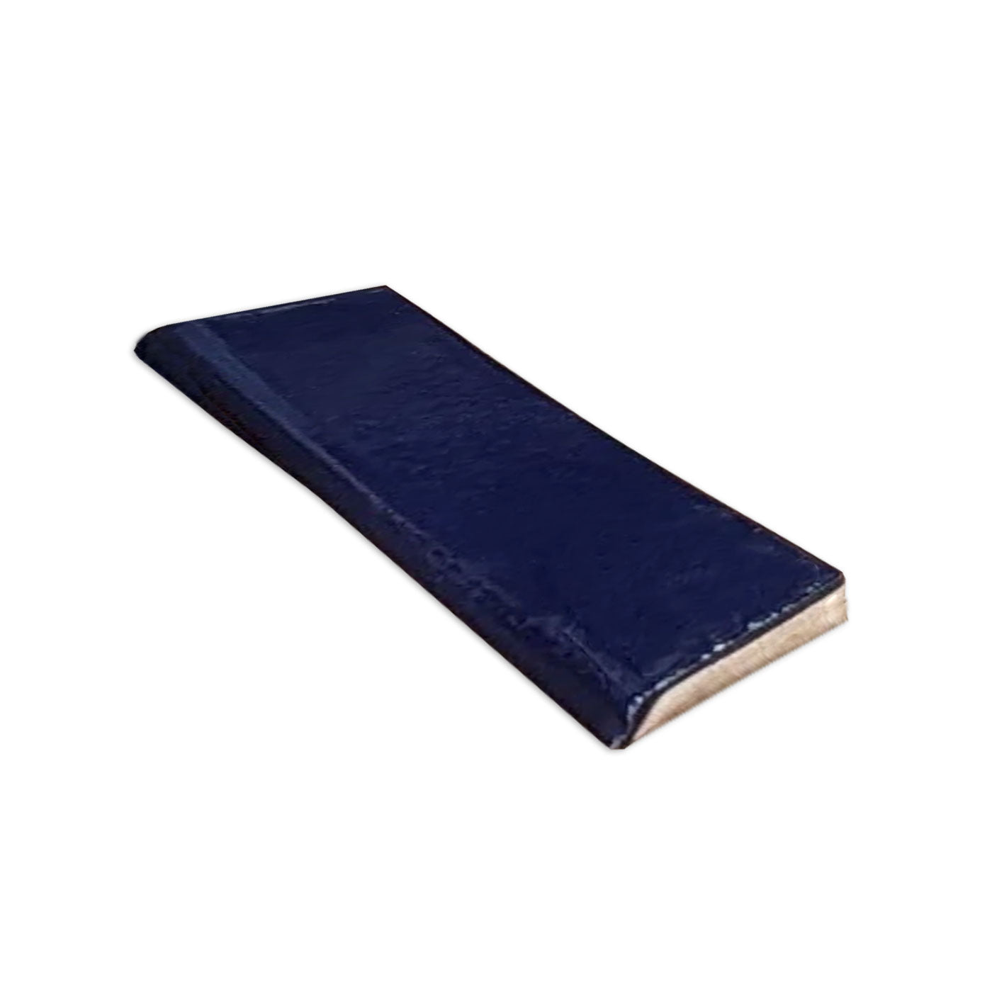 Dark blue gloss 2x8 single bullnose tile by Clay Imports, angled to show its textured surface.