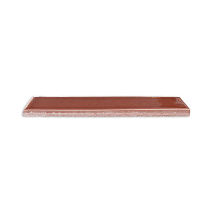Tamarindo glossy solid tile by Clay Imports, rectangular, with a smooth surface and visible textured side.