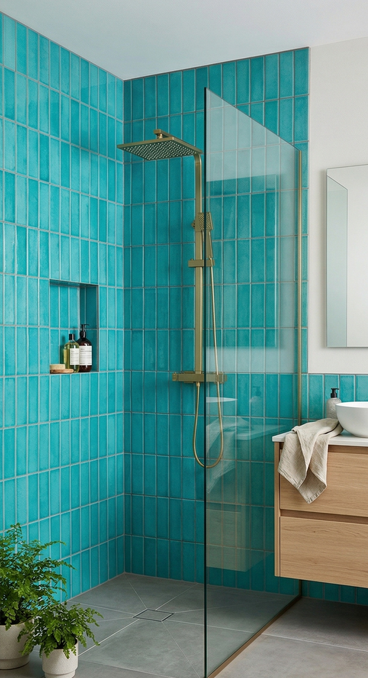 Turquoise crackle 2x8 clay tiles by Clay Imports, vertically stacked on shower walls in a modern bathroom with gold fixtures and a glass screen.