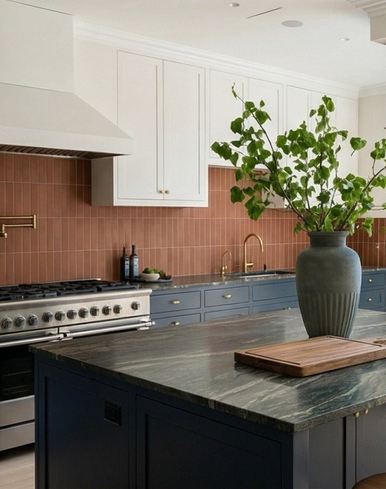 Umber 2x8 Cotto tiles by Clay Imports forming a vertical stack bond backsplash in a modern kitchen.