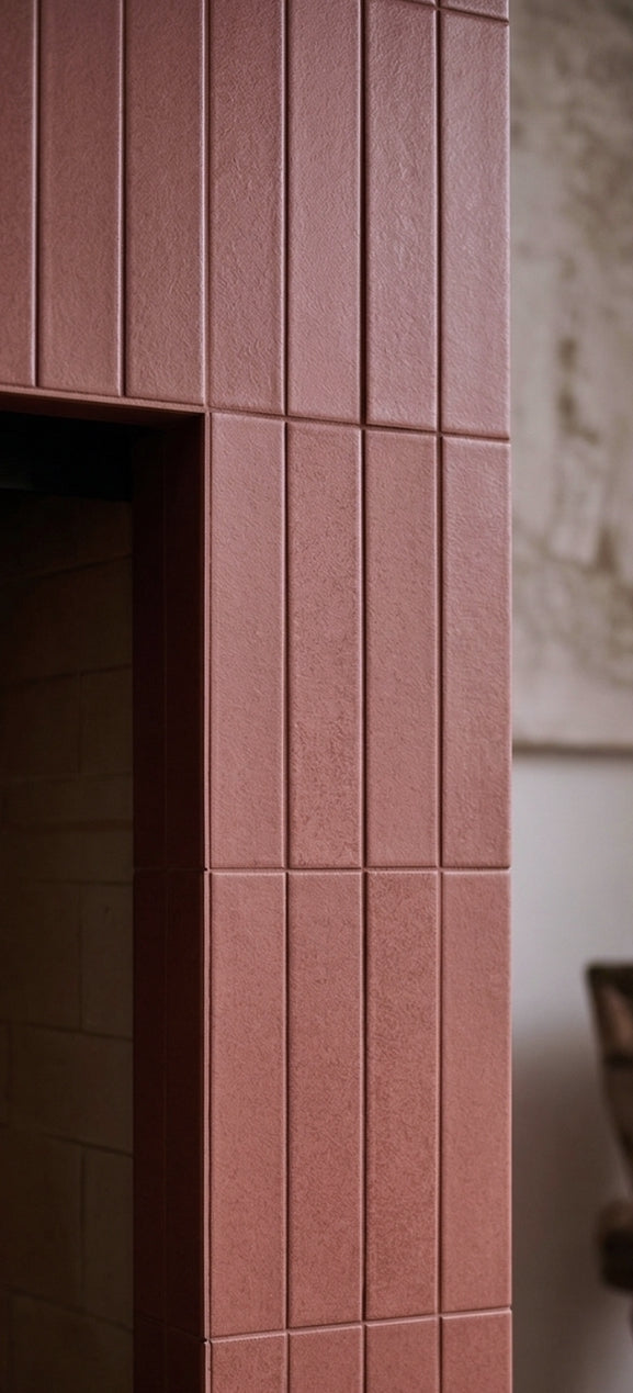 Lava Rock Matte 2x12 solid tile by Clay Imports, vertically laid on a fireplace surround.