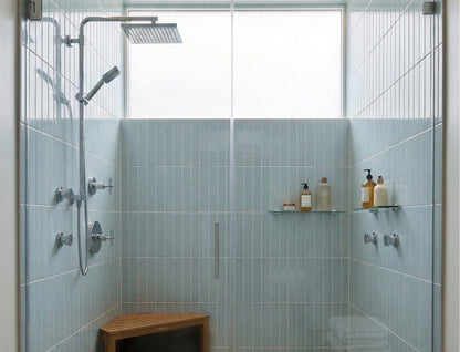 Glossy light blue solid tiles by Clay Imports, vertically installed in a modern shower with chrome fixtures.