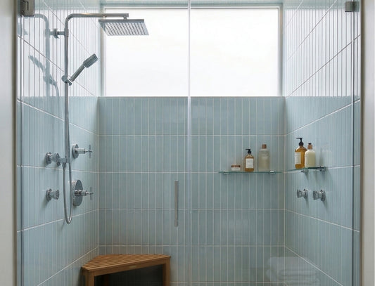 Glossy light blue solid tiles by Clay Imports, vertically installed in a modern shower with chrome fixtures.